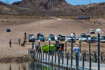 Visitors walk onto the Lake Mead Marina in Hemenway Harbor in the Lake Mead National Recreation ...