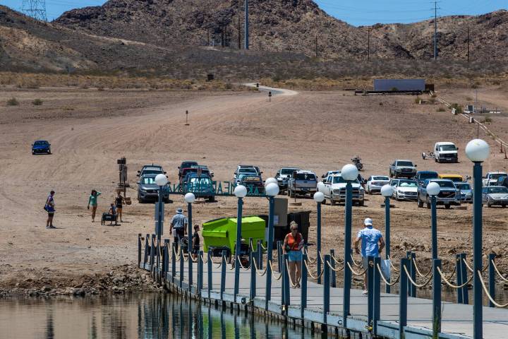 Visitors walk onto the Lake Mead Marina in Hemenway Harbor in the Lake Mead National Recreation ...