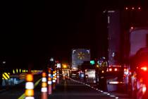 Traffic is diverted off the highway as Nevada Highway Patrol officers investigate the scene of ...