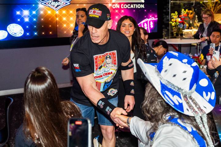 Champion wrestler John Cena visits with fans during a WrestleMania kickoff party hosted by expe ...