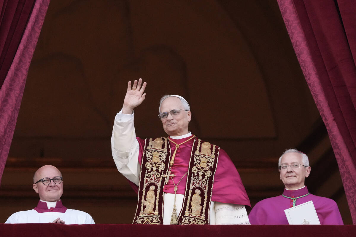 Pope Leo XIV appears on the central loggia of St. Peter's Basilica after being chosen the 267th ...