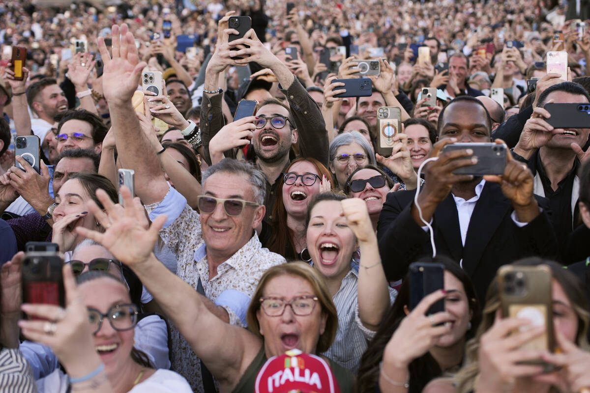 People react as the newly elected Pope Leo XIV appears on the balcony of St. Peter's Basilica a ...
