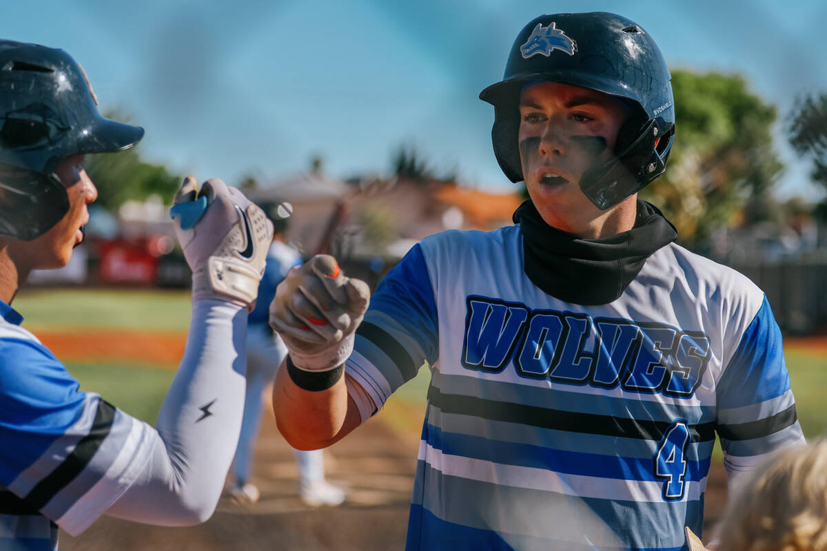 Basic’s Koa Won (4) fist bumps a teammate after hitting a single and being replaced by a ...