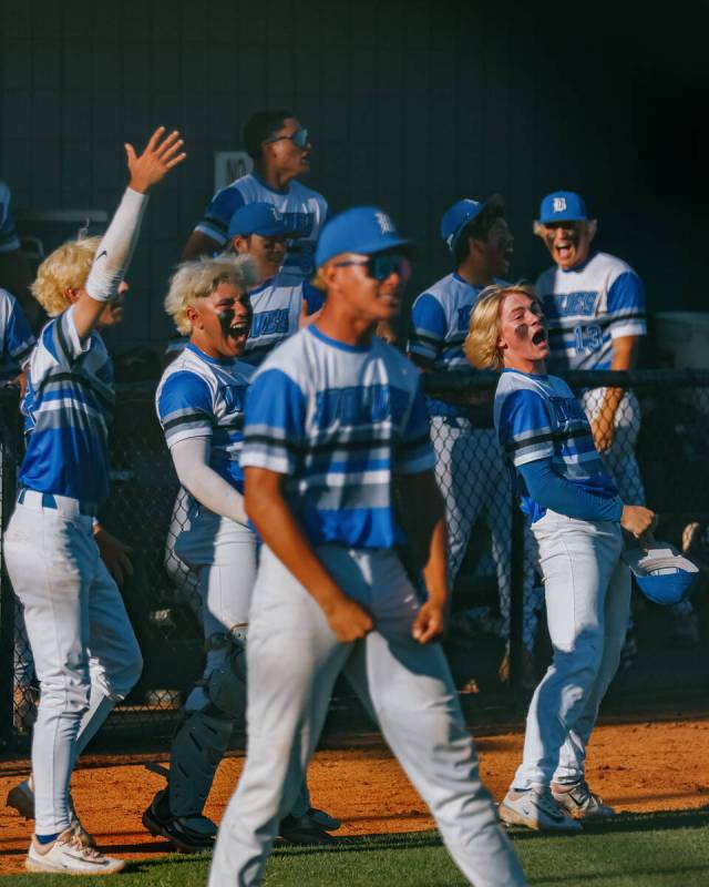 The Basic Academy dugout erupts as teammate Dallon Cegavske (24) scored a game-tying run, keepi ...