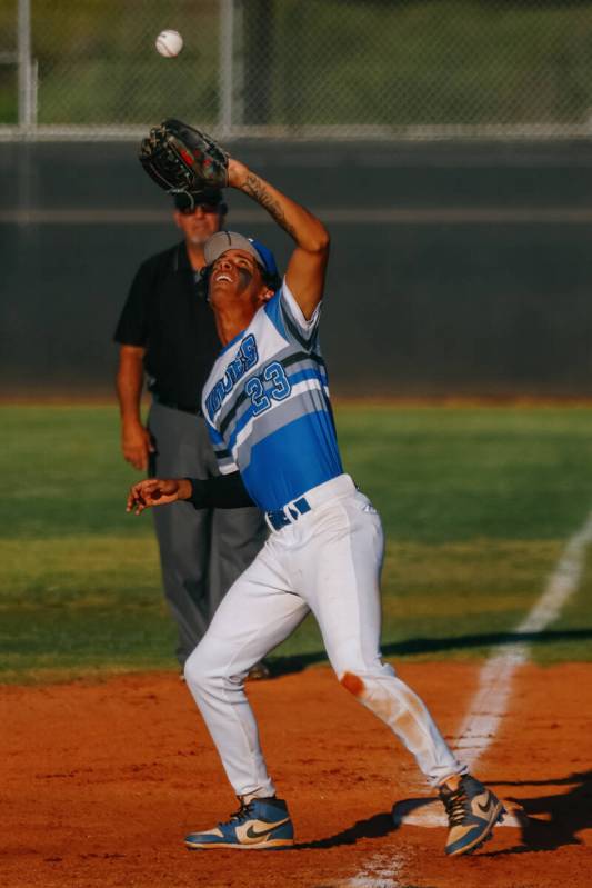 Basic’s Matthew Kelly (23) makes a catch, putting out a Faith Lutheran hitter during the ...
