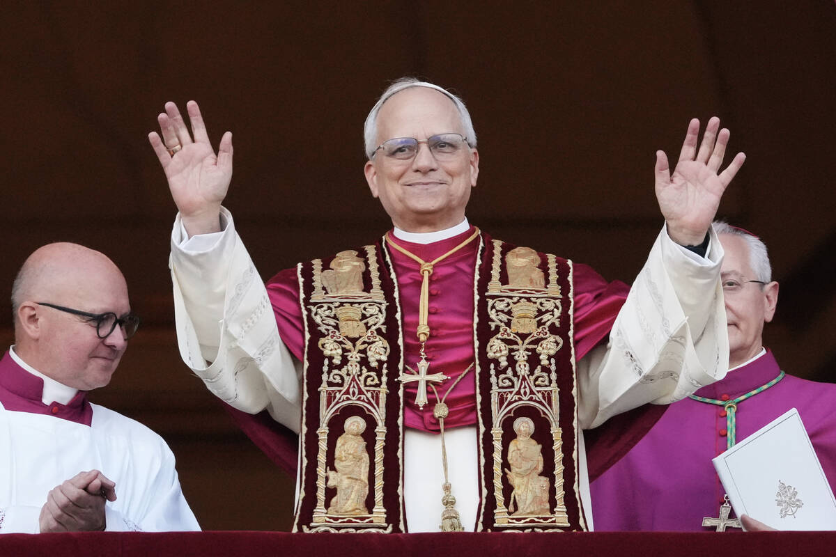 Pope Leo XIV appears on the central loggia of St. Peter's Basilica after being chosen the 267th ...