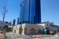 Construction is underway on a boarded-up former WestStar Credit Union branch, front, at 110 E H ...