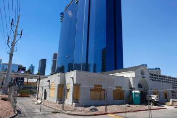 Construction is underway on a boarded-up former WestStar Credit Union branch, front, at 110 E H ...