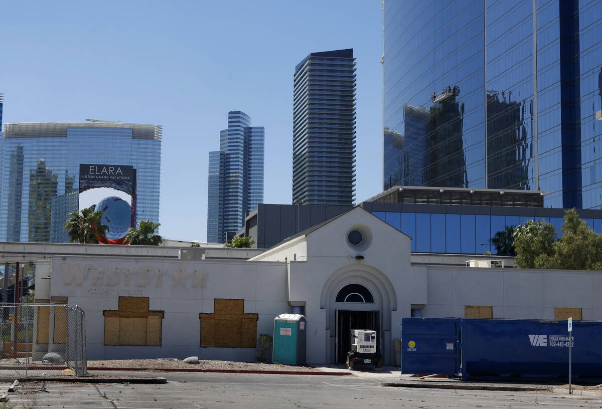 Construction is underway on a boarded-up former WestStar Credit Union branch, front, at 110 E H ...