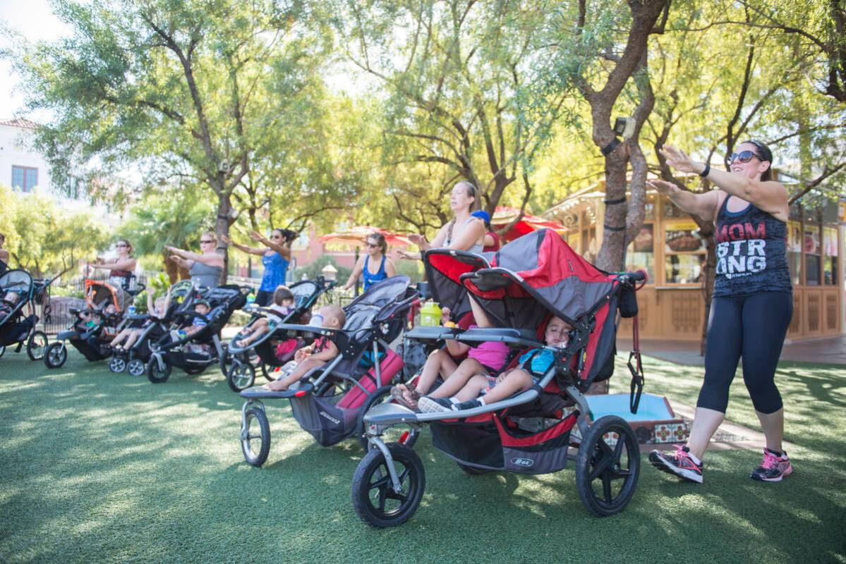 Moms participate in a Stroller Strides class put on by Fit 4 Mom at Town Square in Las Vegas on ...