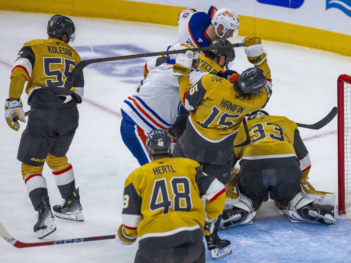 Edmonton Oilers left wing Evander Kane (91) punches Golden Knights defenseman Noah Hanifin (15) ...