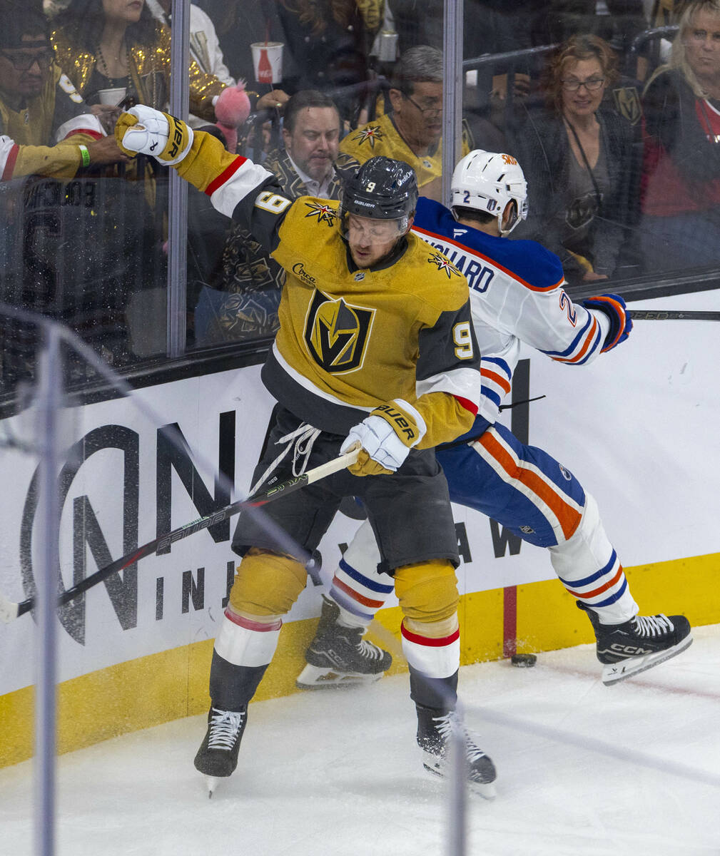 Golden Knights center Jack Eichel (9) collides with Edmonton Oilers defenseman Evan Bouchard (2 ...