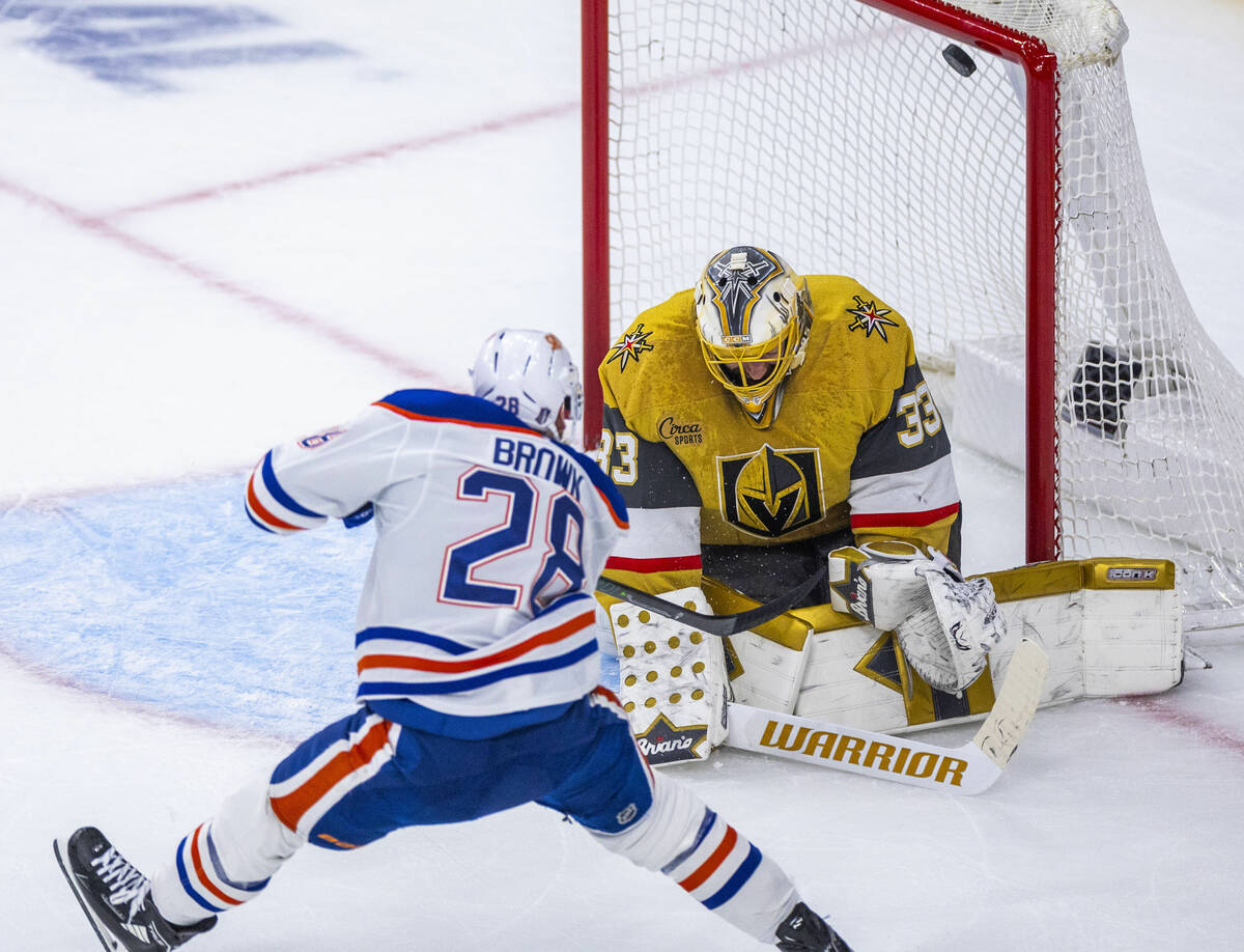 The puck hits the post past Golden Knights goaltender Adin Hill (33) after shot by Edmonton Oil ...