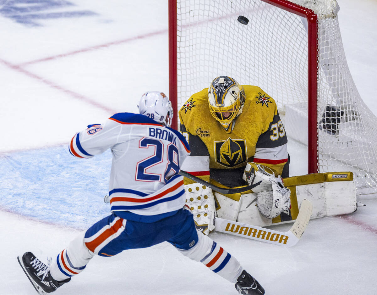 The puck hits the post past Golden Knights goaltender Adin Hill (33) after shot by Edmonton Oil ...