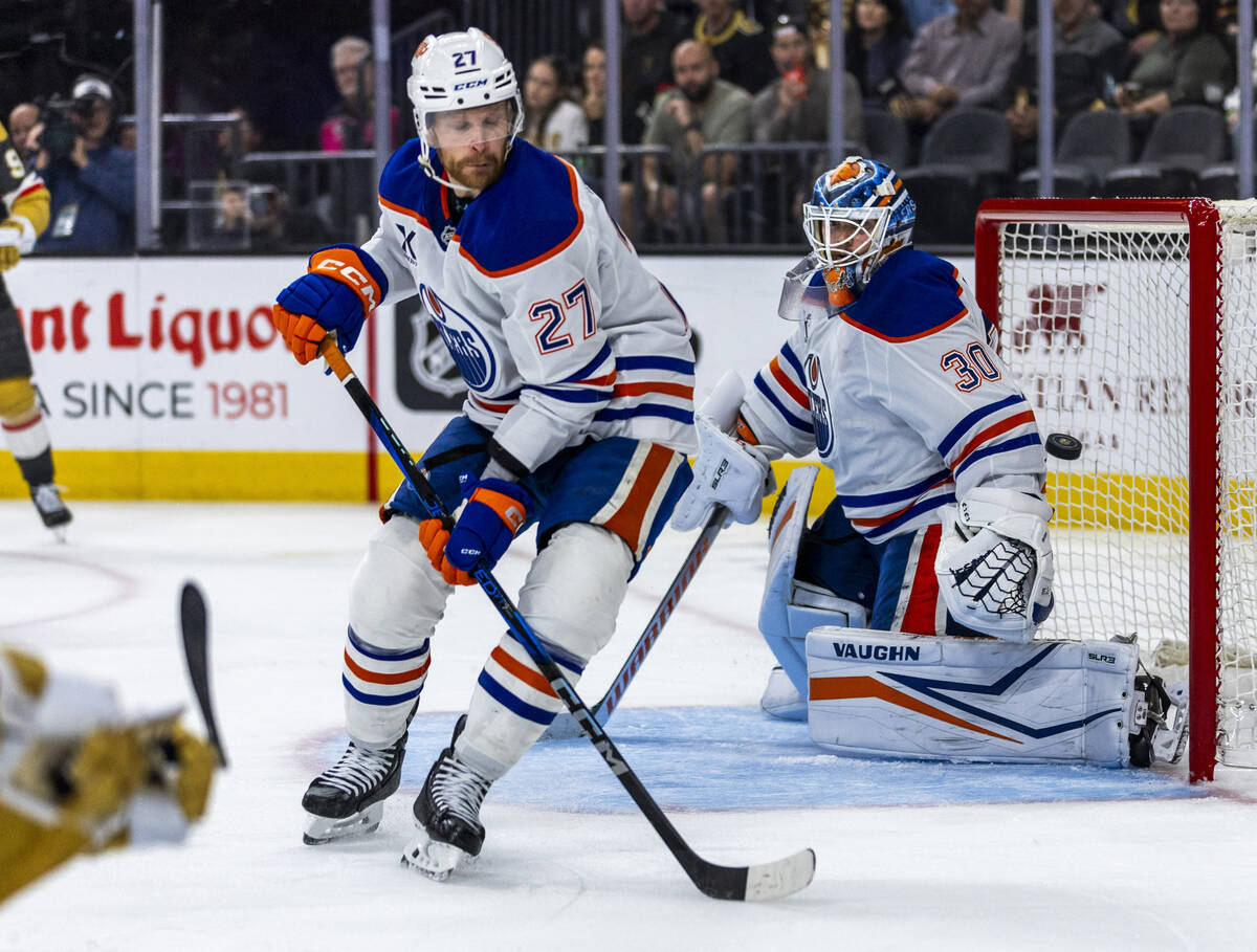 The puck sails past Edmonton Oilers goaltender Calvin Pickard (30) shot by Golden Knights right ...