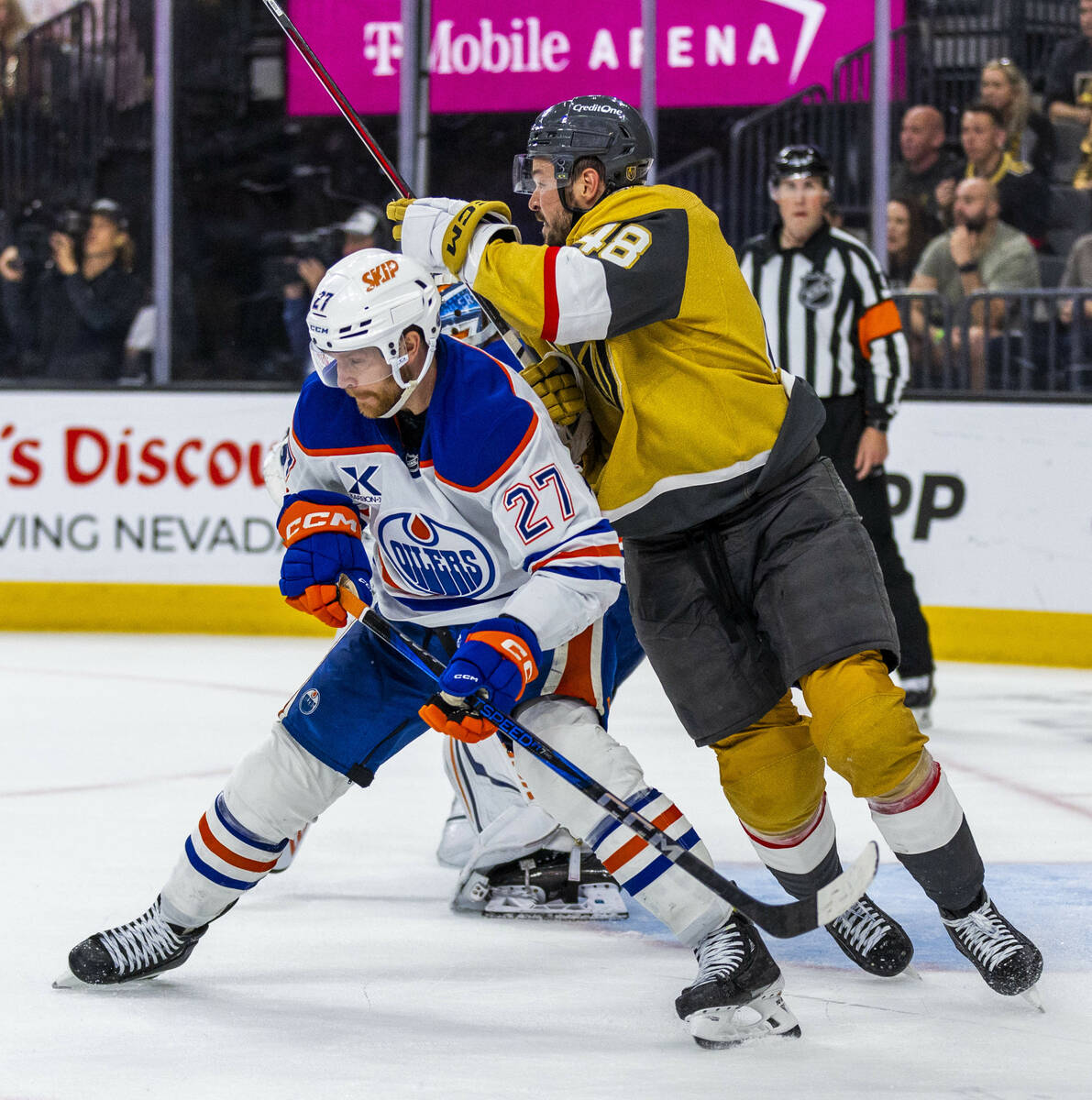 Edmonton Oilers defenseman Brett Kulak (27) defends the net against Golden Knights center Tomas ...