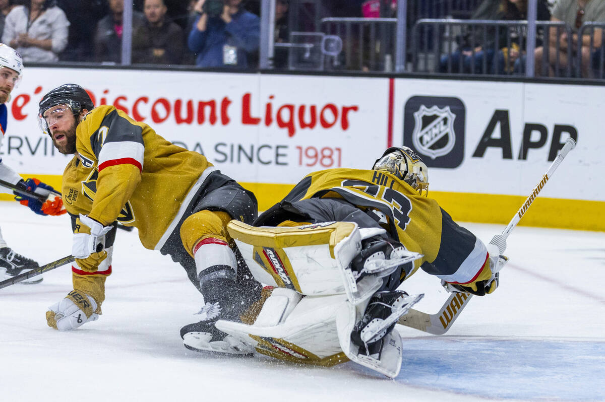 Golden Knights goaltender Adin Hill (33) dives but in unable to stop a shot by Edmonton Oilers ...