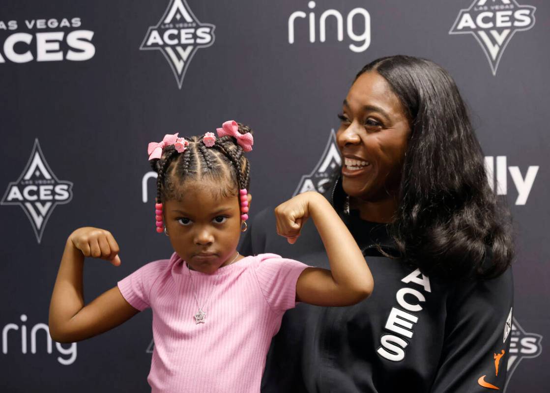 Las Vegas Aces forward Cheyenne Parker-Tyus speaks as her daughter Naomi, 3, flexes her muscles ...