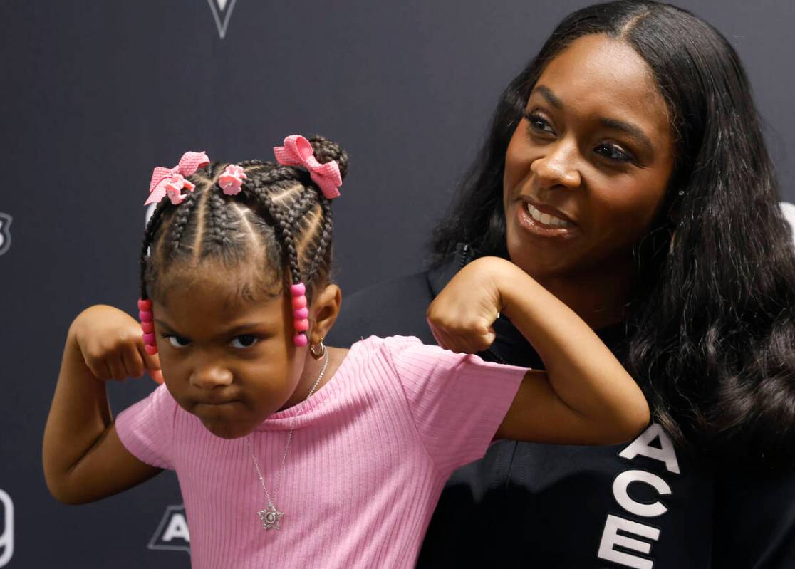 Las Vegas Aces forward Cheyenne Parker-Tyus speaks as her daughter Naomi, 3, flexes her muscles ...