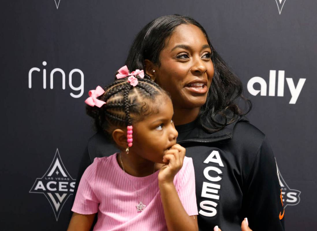 Las Vegas Aces forward Cheyenne Parker-Tyus speaks as her daughter Naomi, 3, looks on during te ...