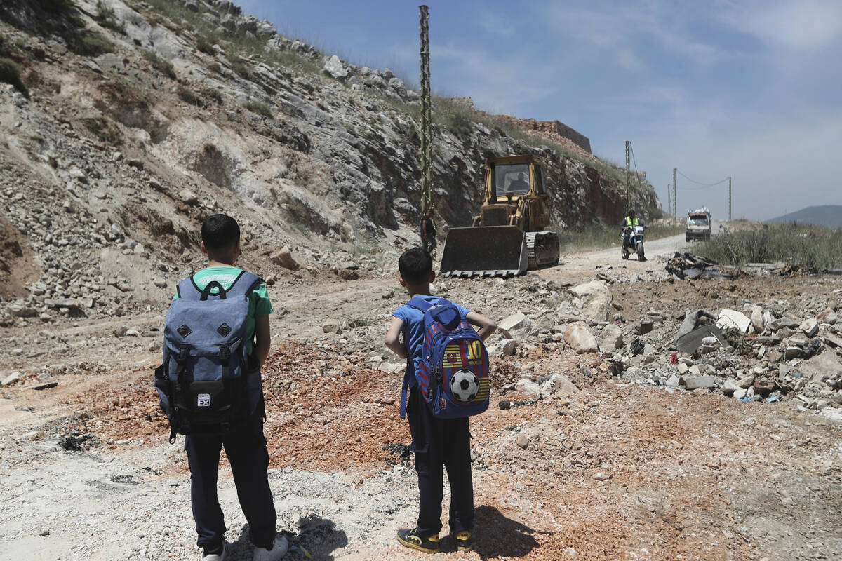A bulldozer fills a crater following Israeli airstrikes that targeted hilltops near Nabatieh to ...