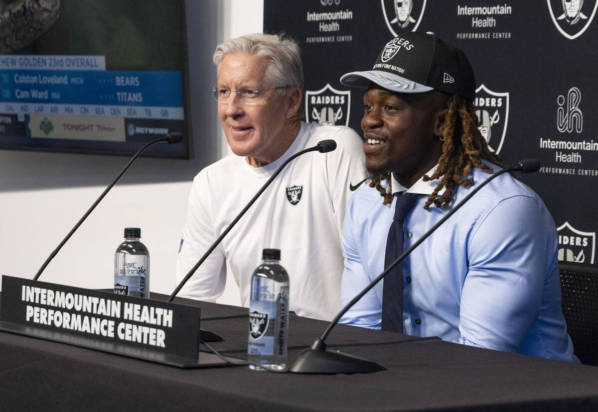 Raiders coach Pete Carroll, left, smiles as first-round draft pick, running back Ashton Jeanty, ...