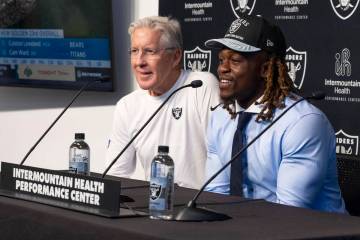 Raiders coach Pete Carroll, left, smiles as first-round draft pick, running back Ashton Jeanty, ...