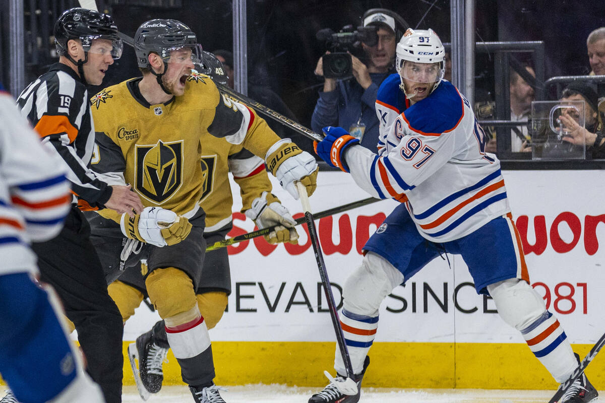 Golden Knights center Jack Eichel (9) reacts to a stick to the back of the head by Edmonton Oil ...