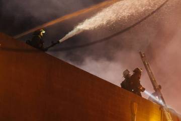Firefighters battle a fire near West Twain Avenue and South Highland Drive on Thursday, May 8, ...