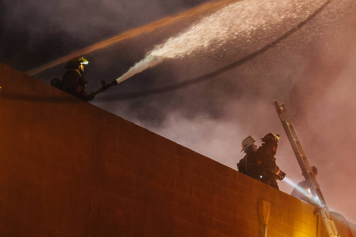 Firefighters battle a fire near West Twain Avenue and South Highland Drive on Thursday, May 8, ...