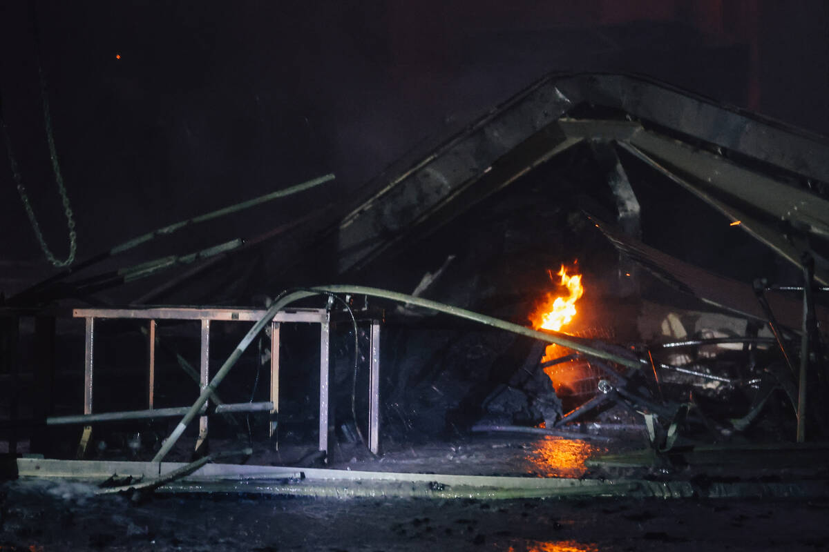 A fire burns near West Twain Avenue and South Highland Drive on Thursday, May 8, 2025, in Las V ...