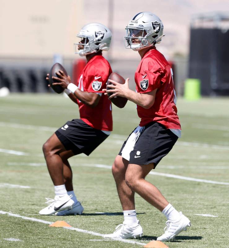 Raider quarterback Cam Miller (5) and former UNLV quarterback Hajj-Malik Williams, left, prepar ...