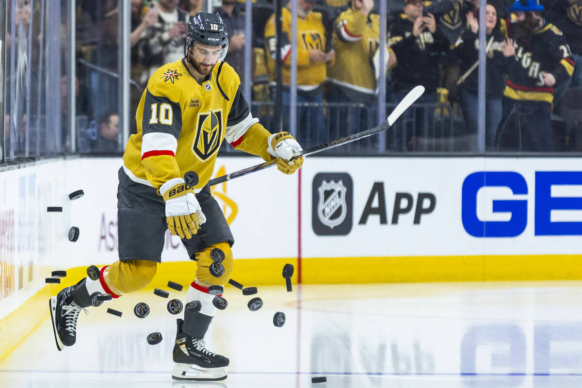 Golden Knights center Nicolas Roy (10) knocks down a stack of pucks during warm ups before faci ...