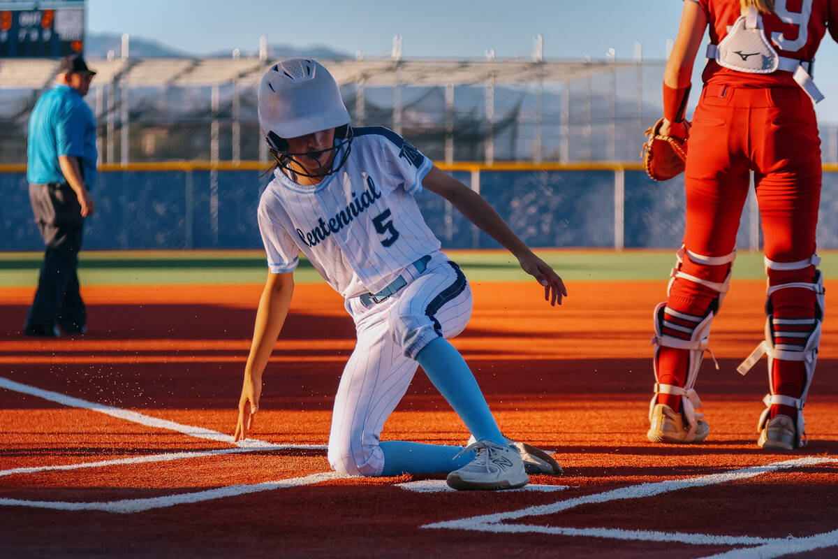 Centennial’s Valeria Lopez (5) slides home, earning a run for the Bulldogs during the NI ...