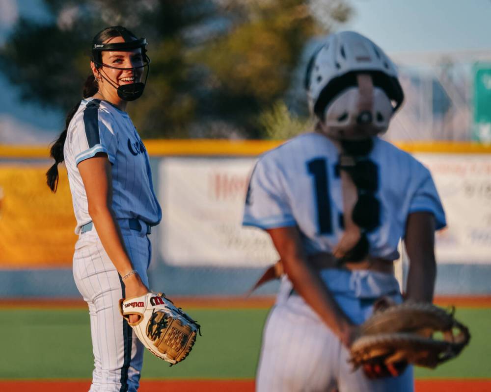 Centennial pitcher Lily Fournier (4) grins at catcher Amanda Campos-Colon (13) as she approache ...
