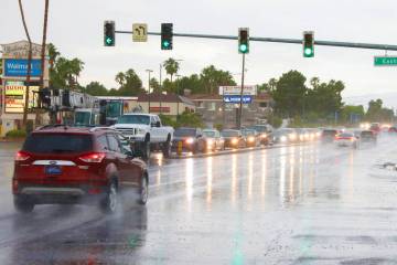 A car drives through the intersection of Warms Springs road and Eastern avenue during an early ...