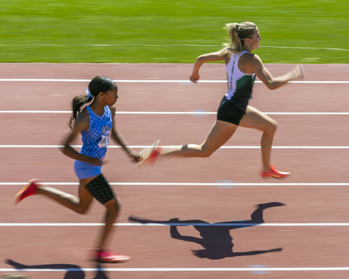Palo Verde's Berklie Ahlander (6124) leads Centennial's Kennedy Hunter (5872) in the girls 100 ...