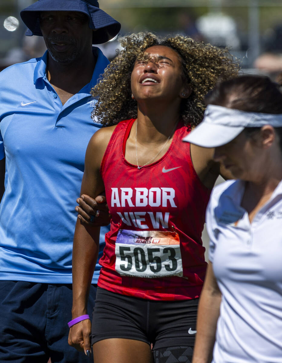 Arbor View's Timmia Rucks (5053) cries in pain from an injury after the 4A girls 100 meter dash ...