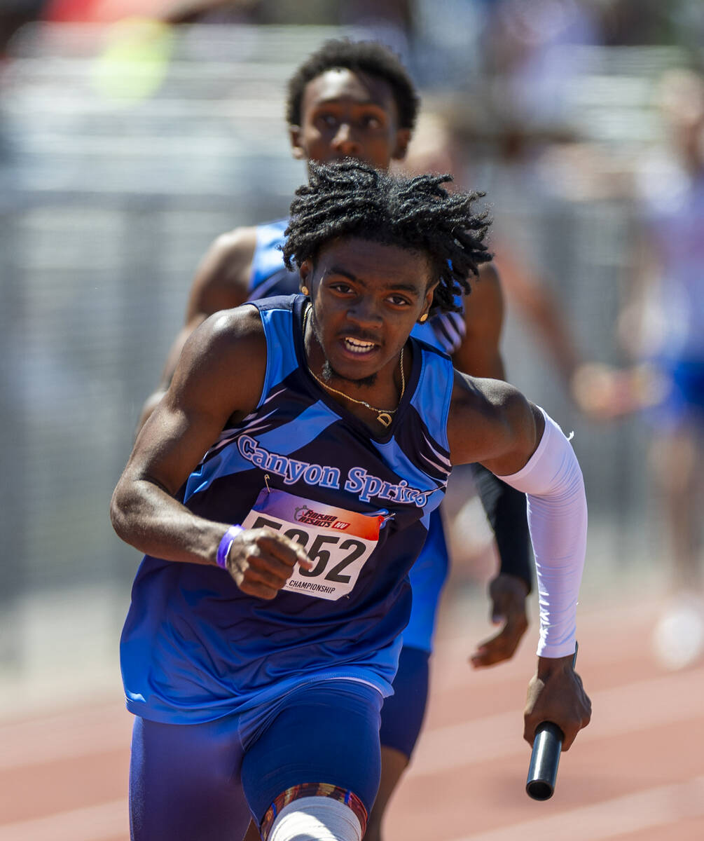 Canyon Springs' De'Andre Jenkins (5852) runs with the baton received from his teammate on the w ...