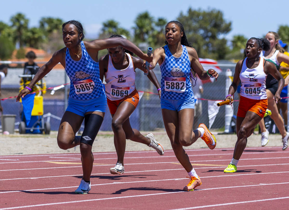 Centennial's Synai Davis (5865) takes the baton from a teammate in the girls 4x200 meter relay ...