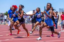 Centennial's Synai Davis (5865) takes the lead in the girls 4x200 meter relay during the Class ...