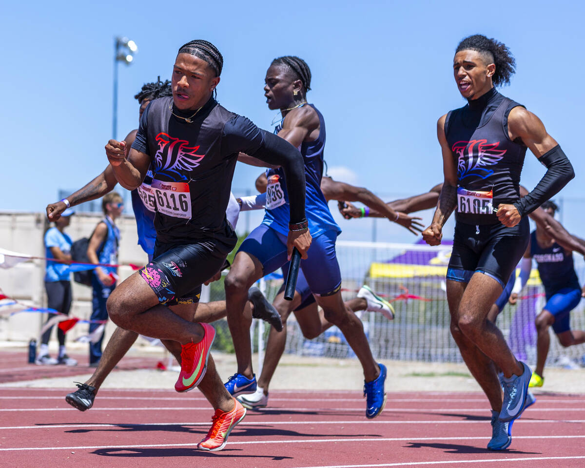 Liberty runners exchange the baton in the boys 4x200 meter relay during the Class 5A Southern R ...