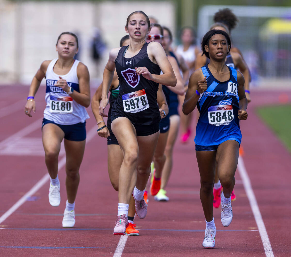 Faith Lutheran's Julia Vancura (5978) runs side by side with Canyon Springs' Trey Mills (5848) ...