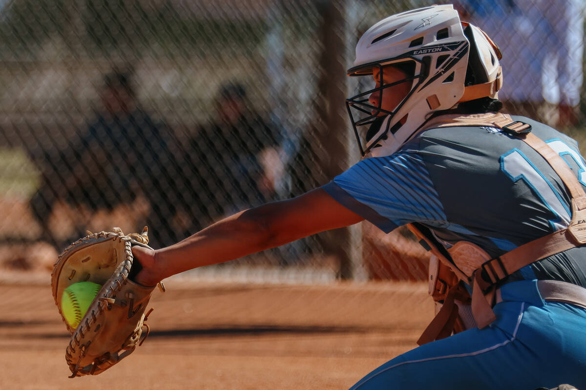 Centennial catcher Amanda Campos-Colon (13) catches a pitch from teammate Sloane Merrell during ...