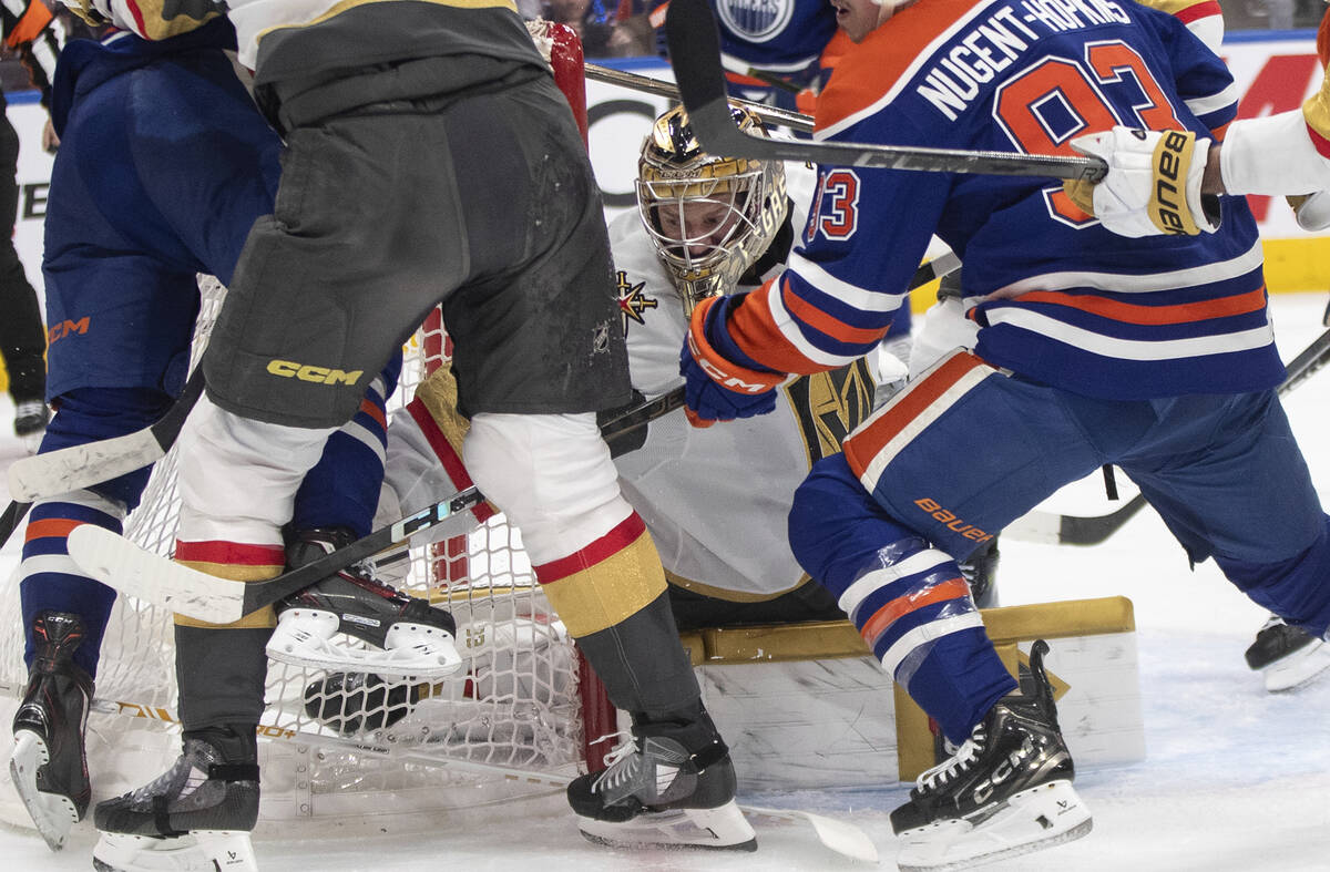 Vegas Golden Knights goalie Adin Hill, center, looks for the puck during the second period of G ...