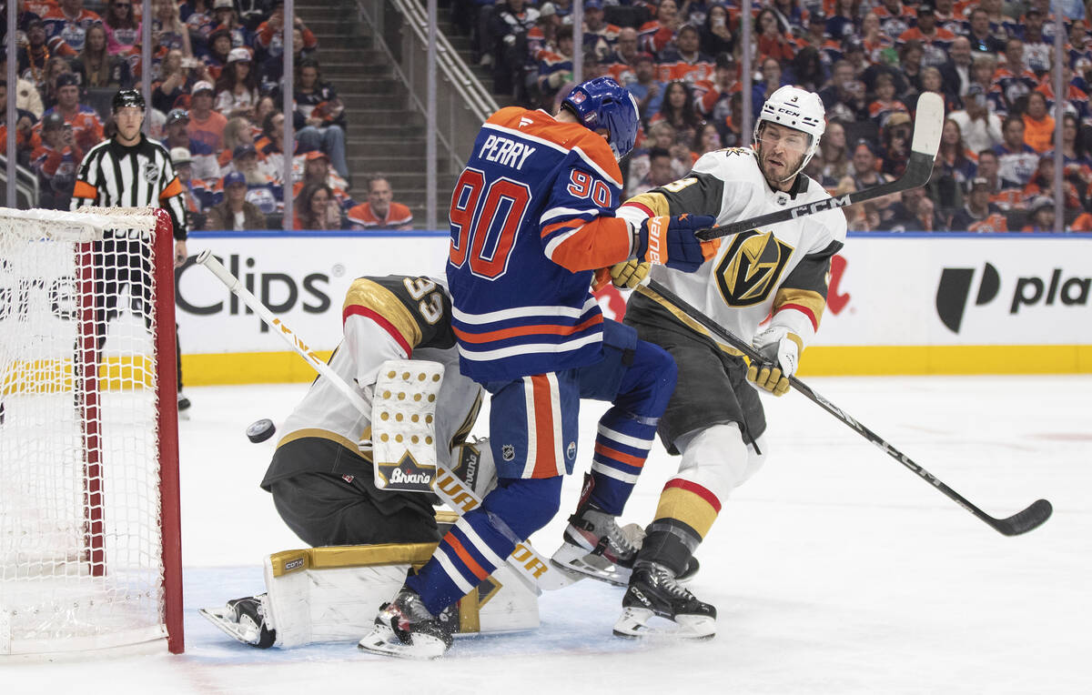 Vegas Golden Knights goalie Adin Hill (33) makes a save as Brayden McNabb (3) and Edmonton Oile ...