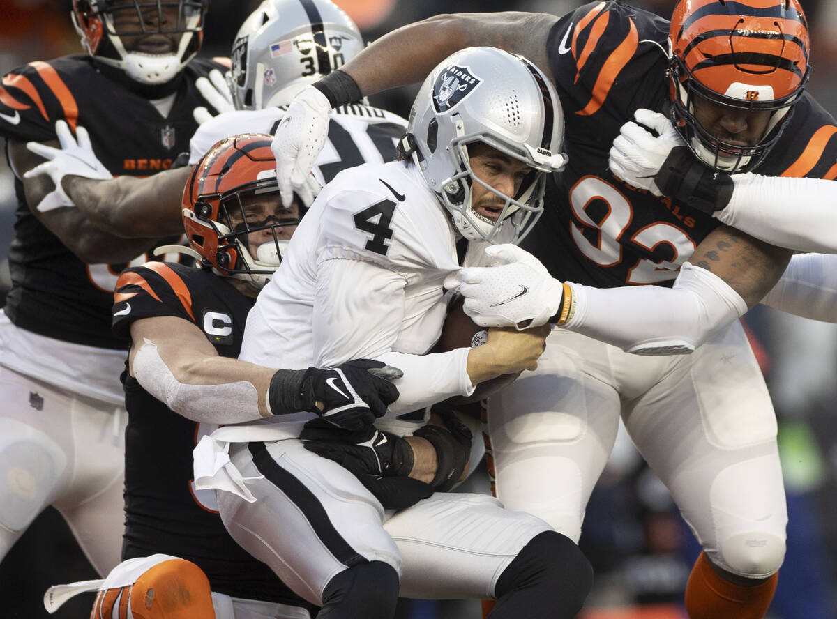 Raiders quarterback Derek Carr (4) is sacked at the goal line by Cincinnati Bengals defensive e ...