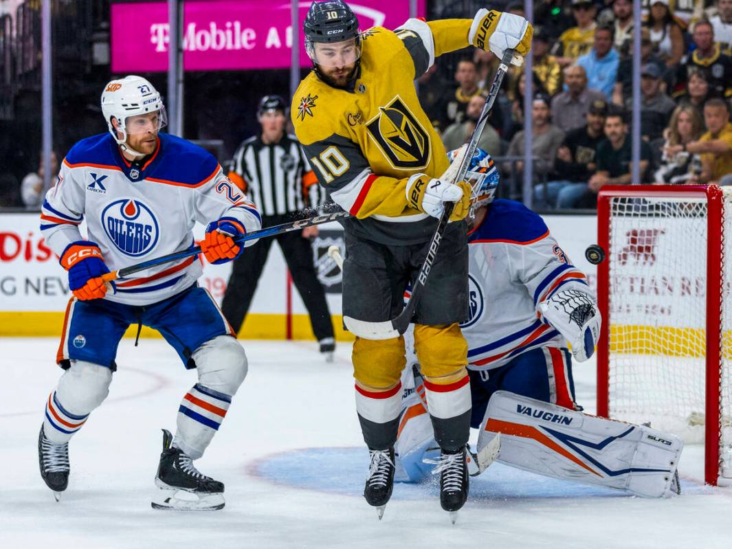 Golden Knights center Nicolas Roy (10) deflects a shot at the net and nearly wins the game past ...
