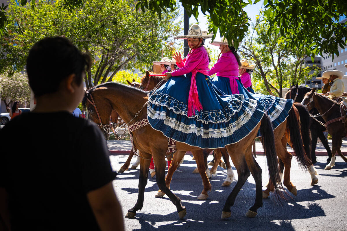 Parade participants with Escaramuza Charra Colibríes de Nevada wave to the crowd during th ...