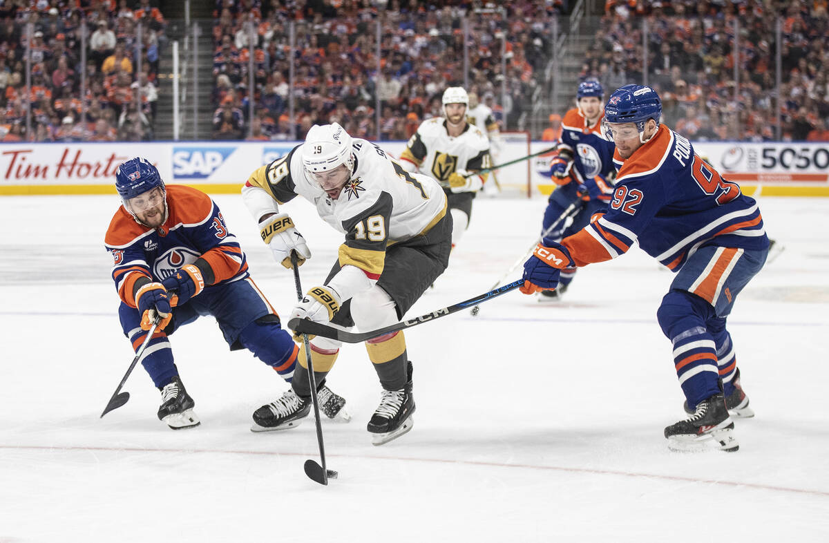 Vegas Golden Knights' Reilly Smith (19) skates between Edmonton Oilers' Viktor Arvidsson (33) a ...